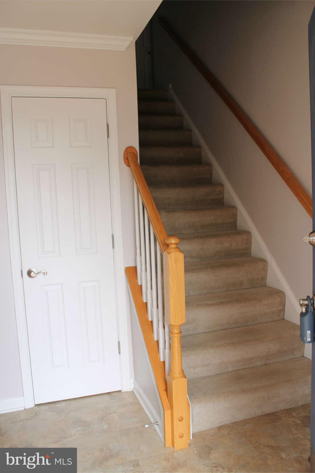 107 Estate Lane Ranson, WV 25438 - Photo 5 of 30 a view of staircase with wooden floor and white walls