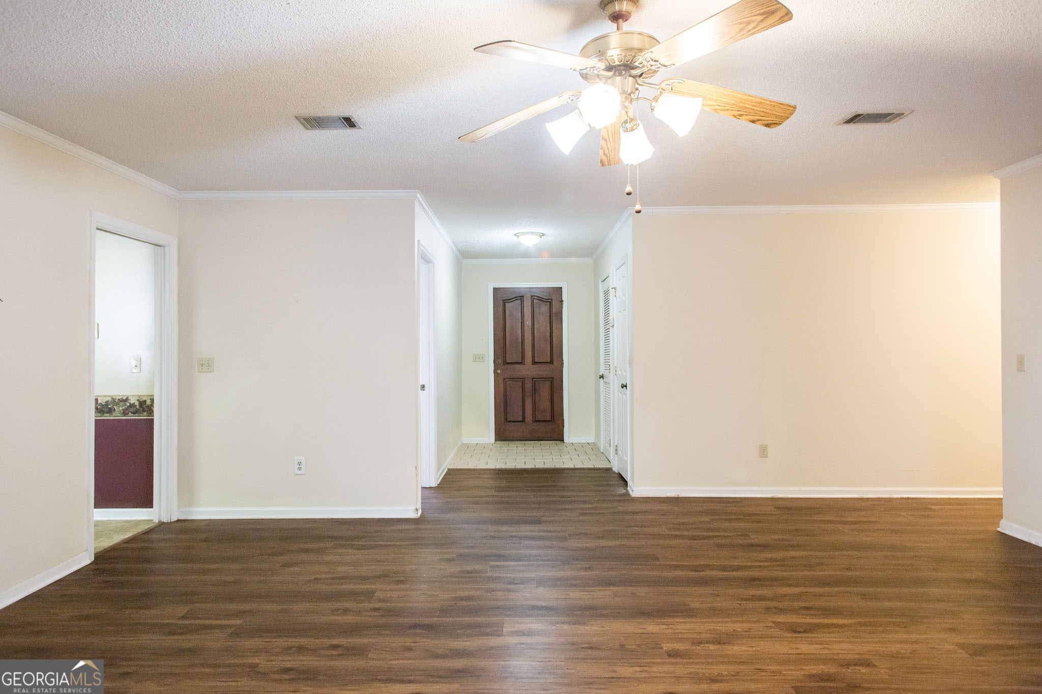 2959 Chadwick Drive Waycross, GA 31501 - Photo 20 of 52 a view of an empty room with wooden floor