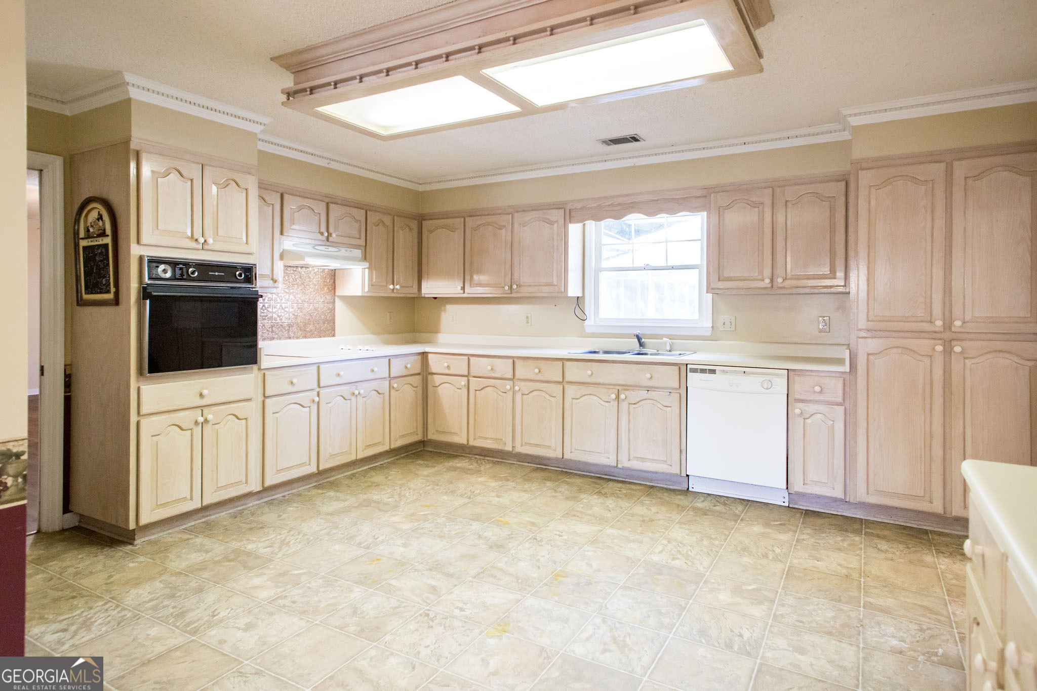 2959 Chadwick Drive Waycross, GA 31501 - Photo 29 of 52 a white kitchen with a sink window and cabinets