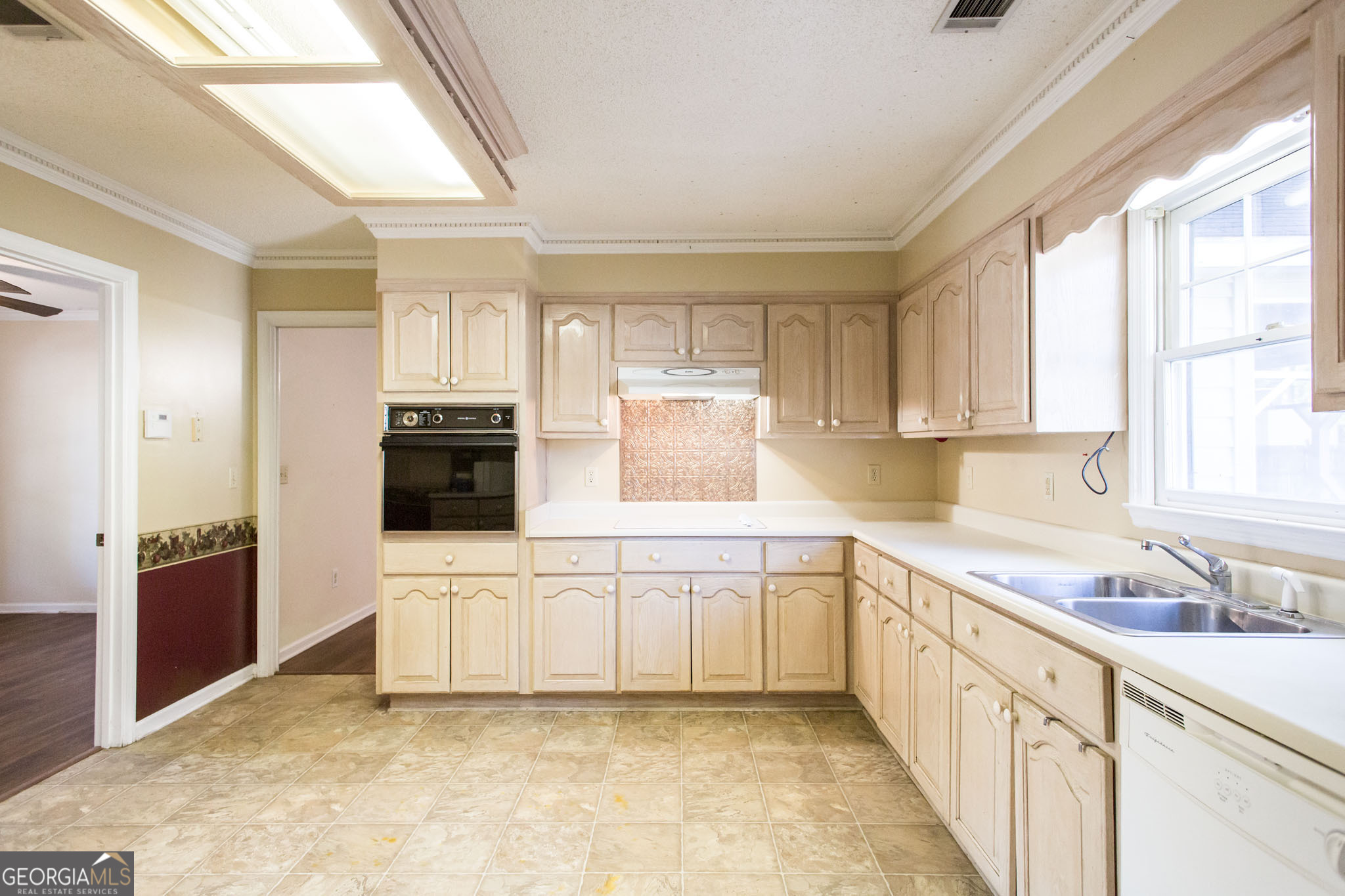 2959 Chadwick Drive Waycross, GA 31501 - Photo 34 of 52 a kitchen with white cabinets and white appliances