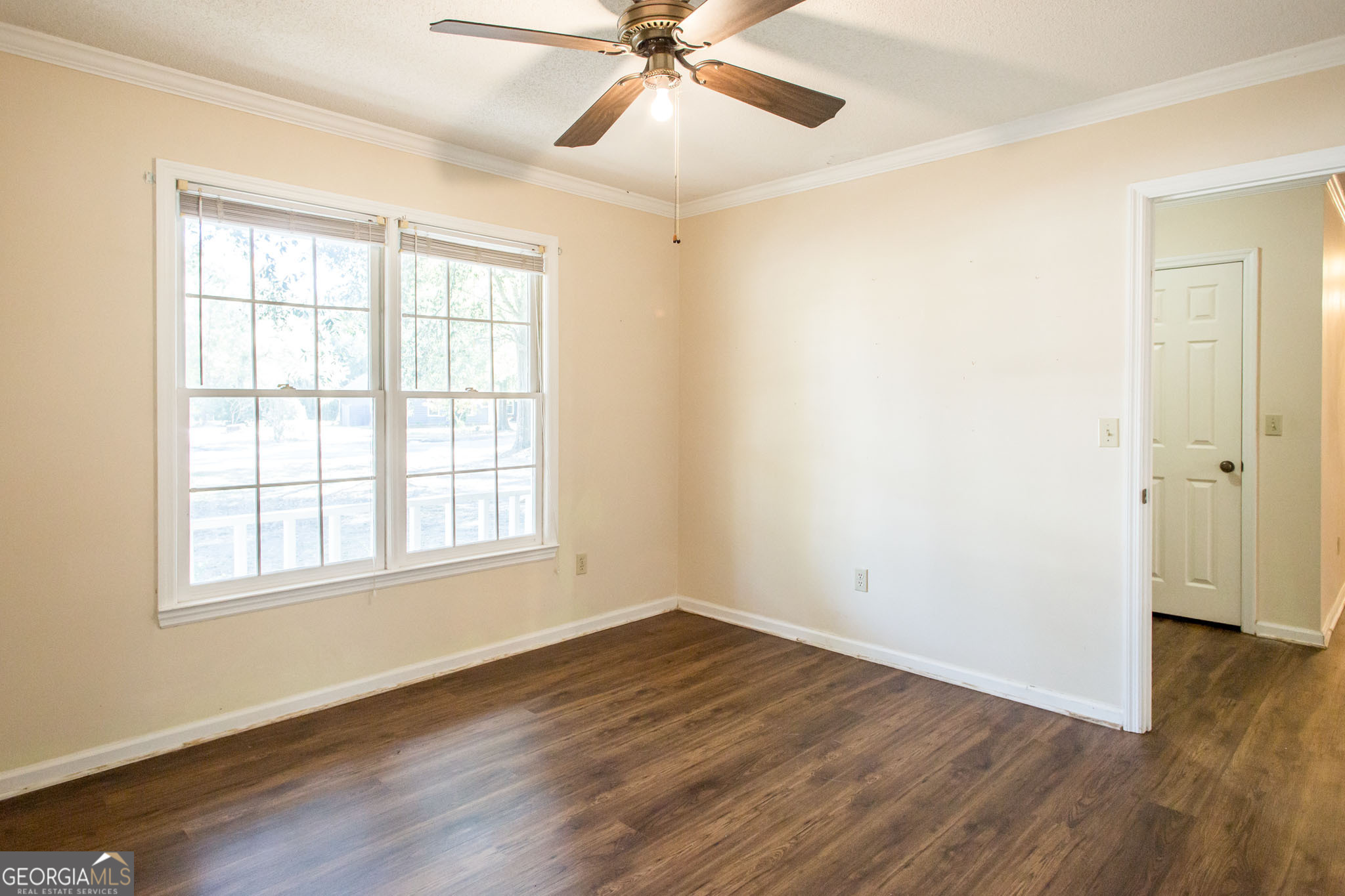 2959 Chadwick Drive Waycross, GA 31501 - Photo 35 of 52 an empty room with wooden floor and windows