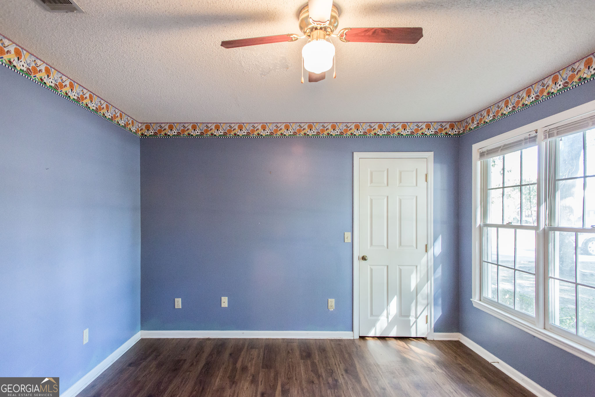 2959 Chadwick Drive Waycross, GA 31501 - Photo 37 of 52 a view of empty room with wooden floor and fan