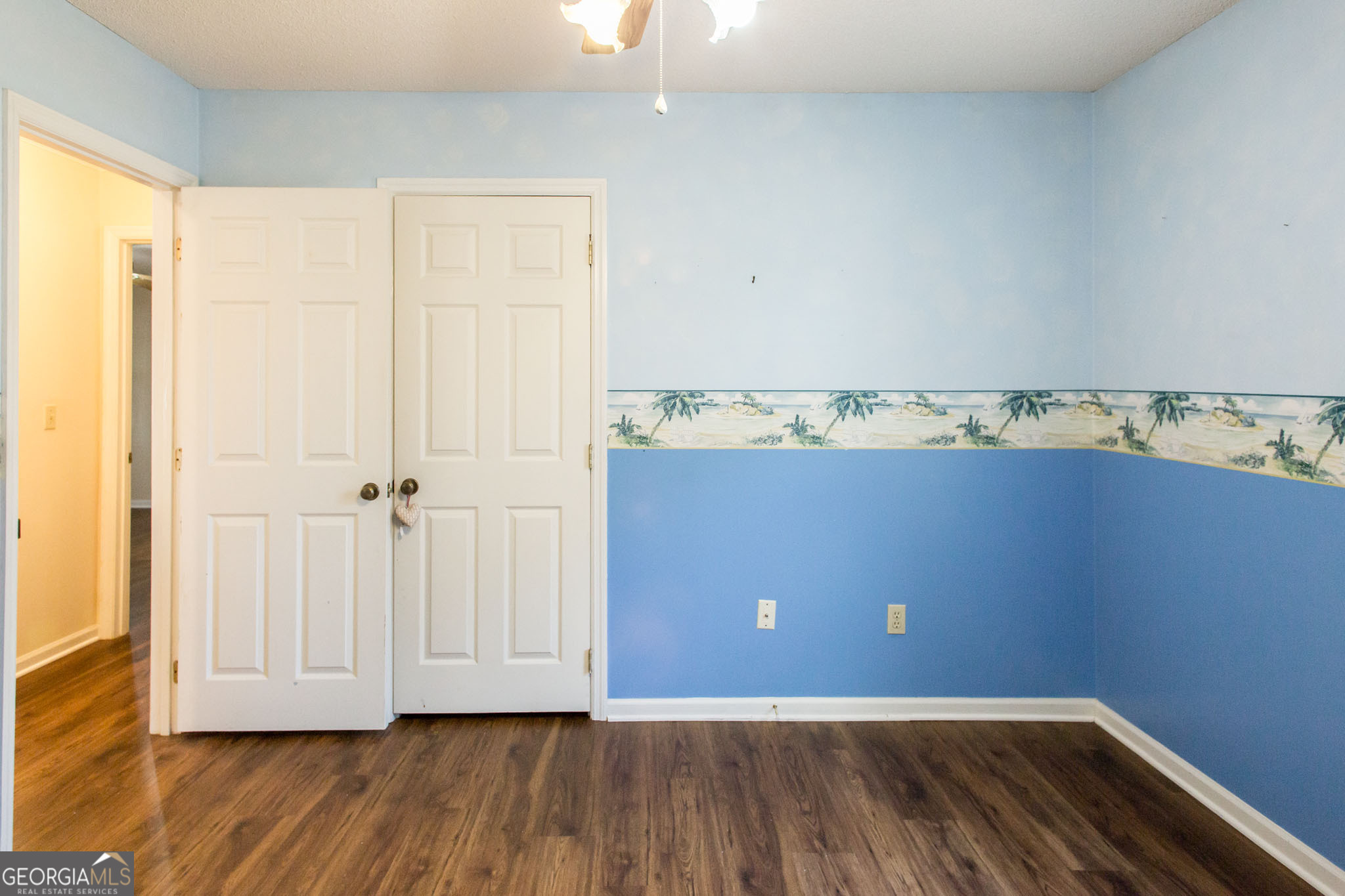 2959 Chadwick Drive Waycross, GA 31501 - Photo 40 of 52 an empty room with wooden floor and cabinet