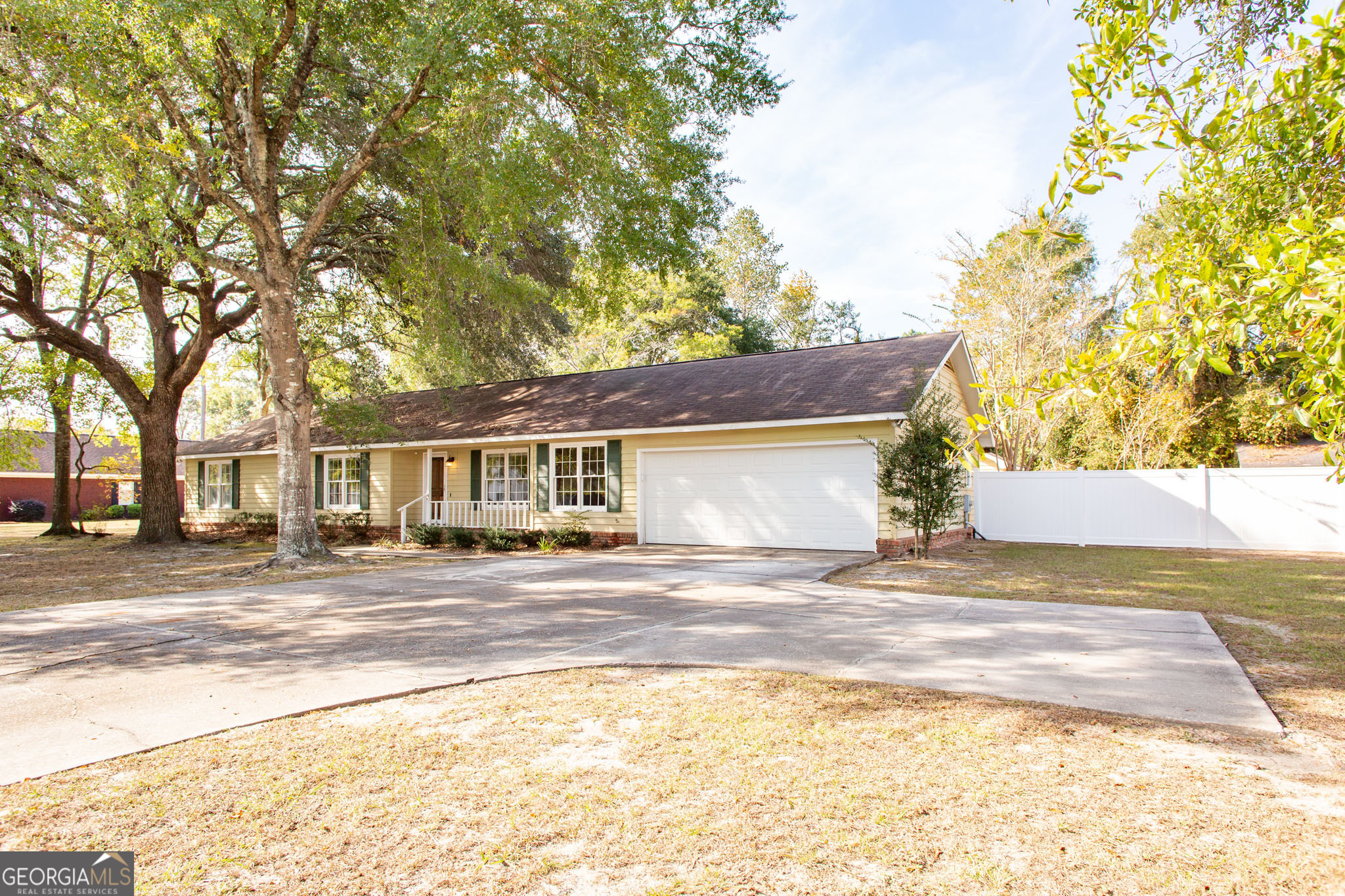 2959 Chadwick Drive Waycross, GA 31501 - Photo 4 of 52 a front view of a house with a yard and trees