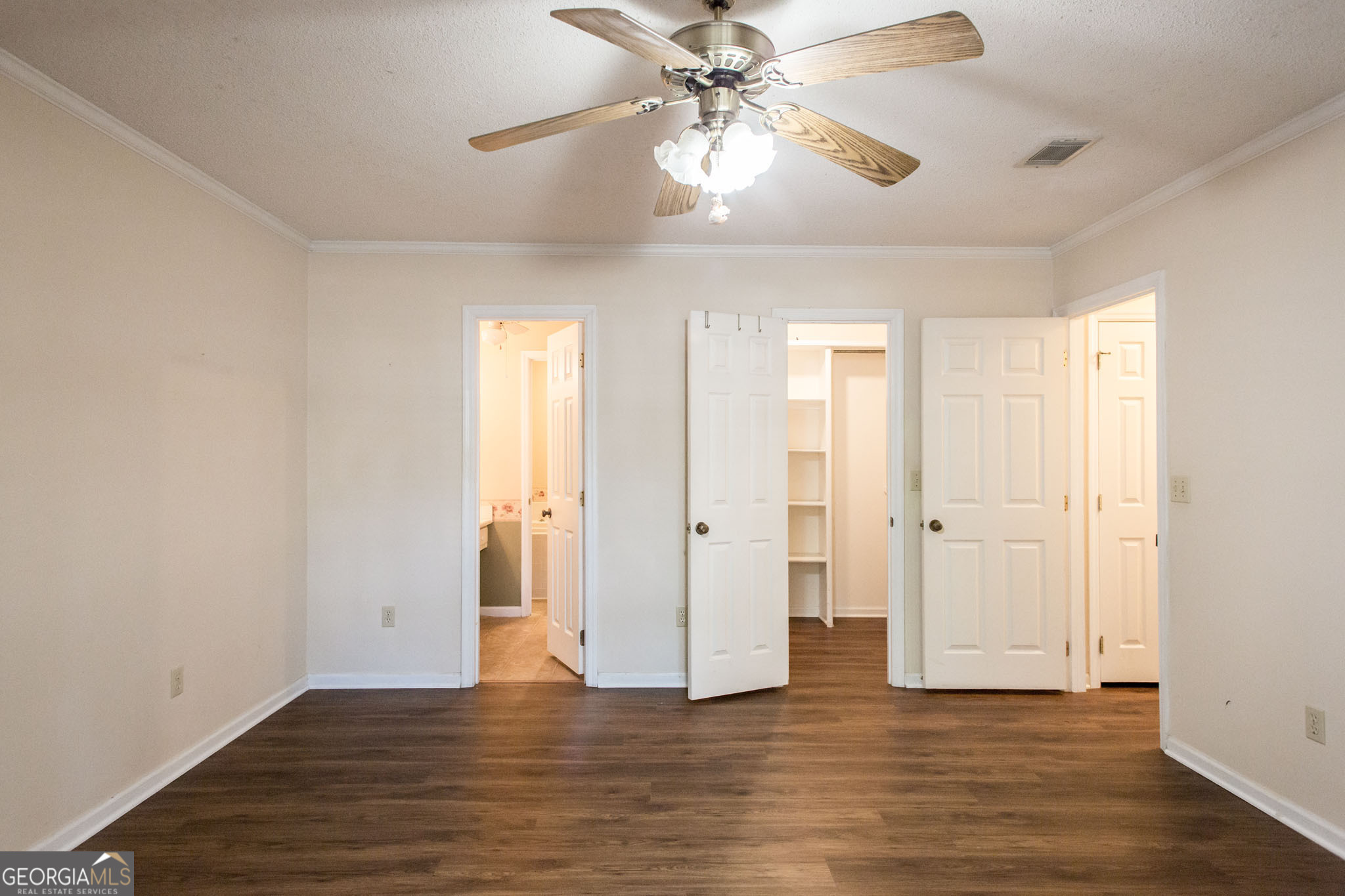 2959 Chadwick Drive Waycross, GA 31501 - Photo 44 of 52 an empty room with wooden floor and ceiling fan