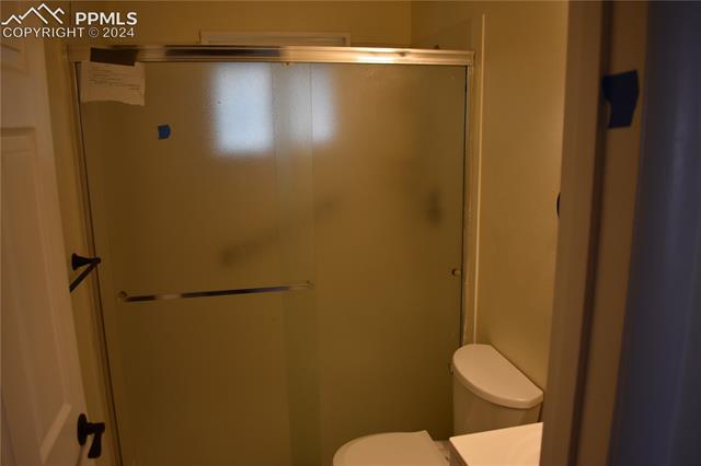 517 Erie Road Colorado Springs, CO 80910 - Photo 7 of 14 Bathroom featuring an enclosed shower and toilet