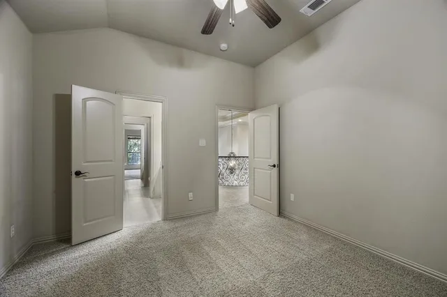 a view of a livingroom with a ceiling fan window and a ceiling fan