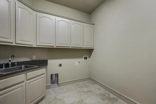 a kitchen with counter top space and windows