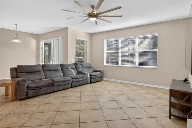 a view of a room with wooden floor and ceiling fan