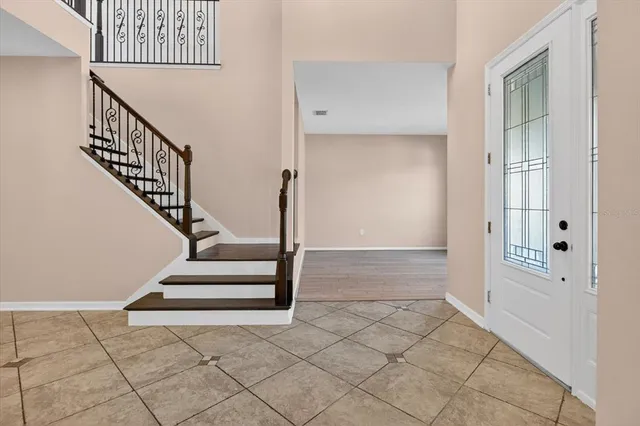 a kitchen with a refrigerator a stove a microwave oven with a dining table and chairs