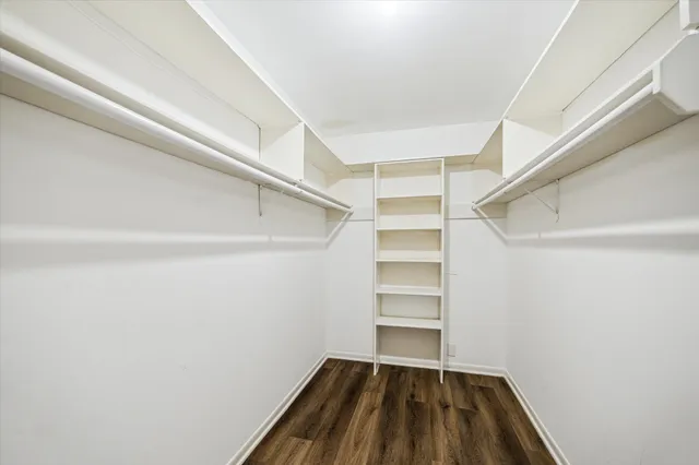 a view of walk in closet with empty racks