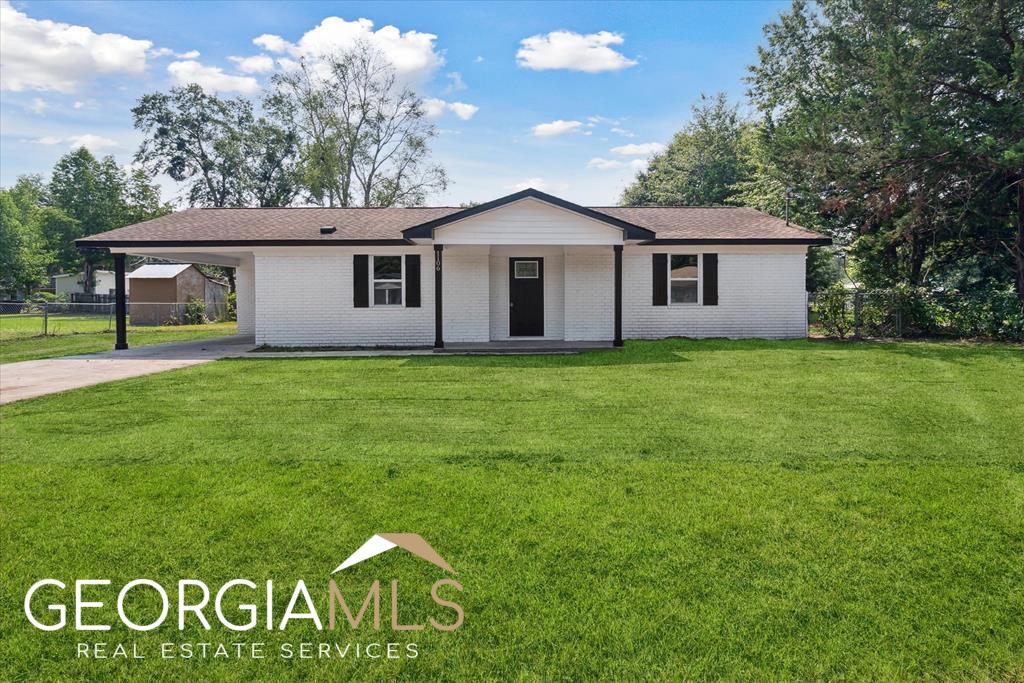 1106 Ricade Drive Fort Stewart, GA 31313 - Photo 1 of 1 a front view of a house with garden