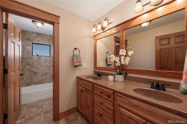 a bathroom with a double vanity sink and a mirror