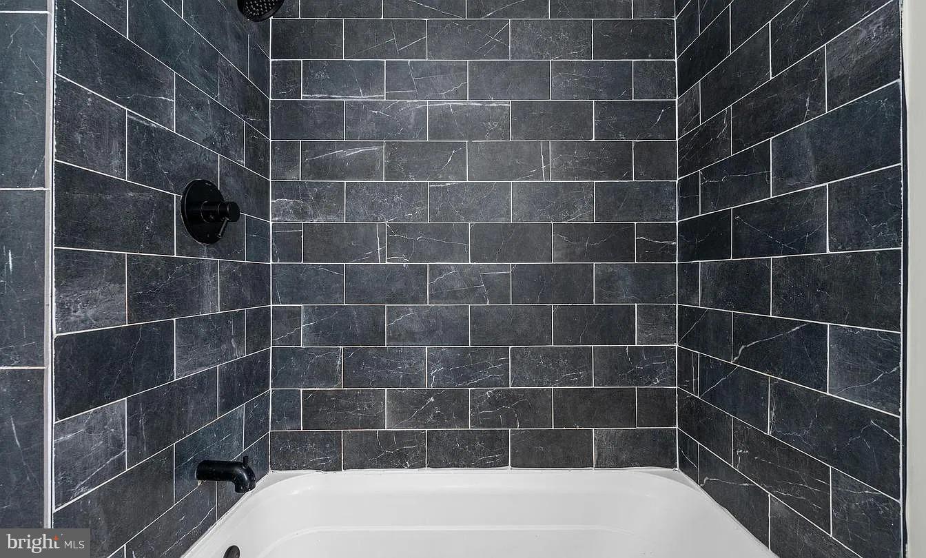 530 Maple Street Reading, PA 19602 - Photo 6 of 10 Sleek modern shower with dark tiles.