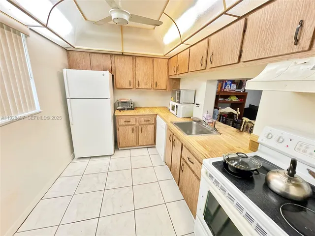 a kitchen with stainless steel appliances a stove a sink and a refrigerator