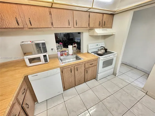 a kitchen with a stove and cabinets