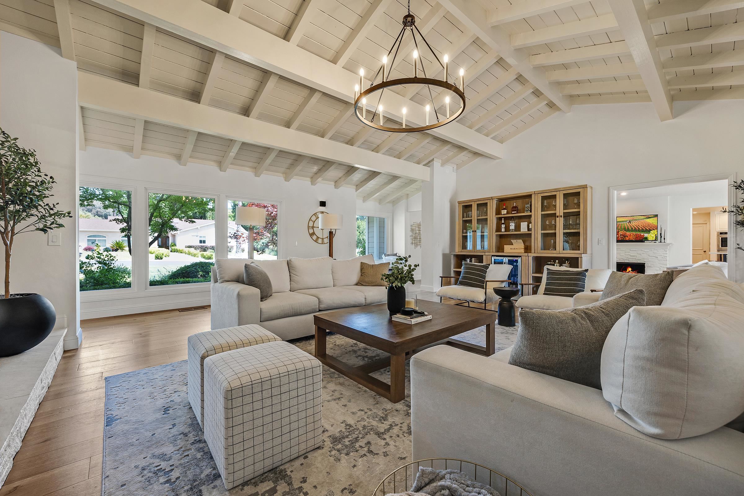 3144 Roundhill Road Alamo, CA 94507 - Photo 18 of 58 a living room with furniture a chandelier and a large window