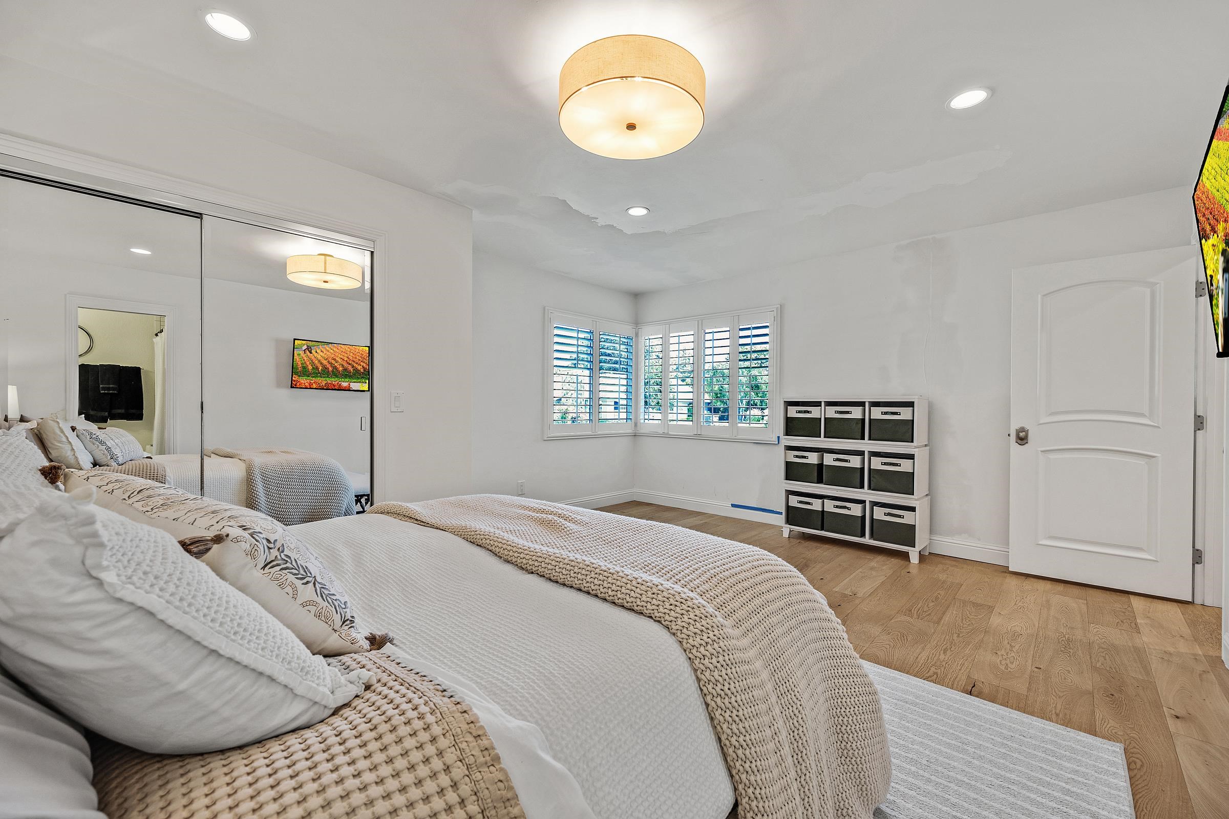 3144 Roundhill Road Alamo, CA 94507 - Photo 32 of 58 a bedroom with a bed and a chandelier