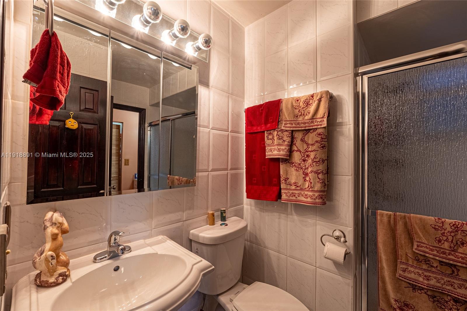 12421 Southwest 193rd Street Miami, FL 33177 - Photo 11 of 23 a bathroom with a sink and a mirror