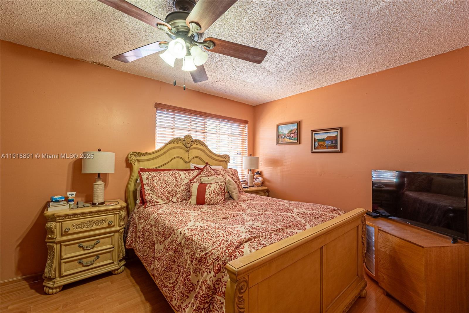 12421 Southwest 193rd Street Miami, FL 33177 - Photo 12 of 23 a bedroom with a bed and a chandelier