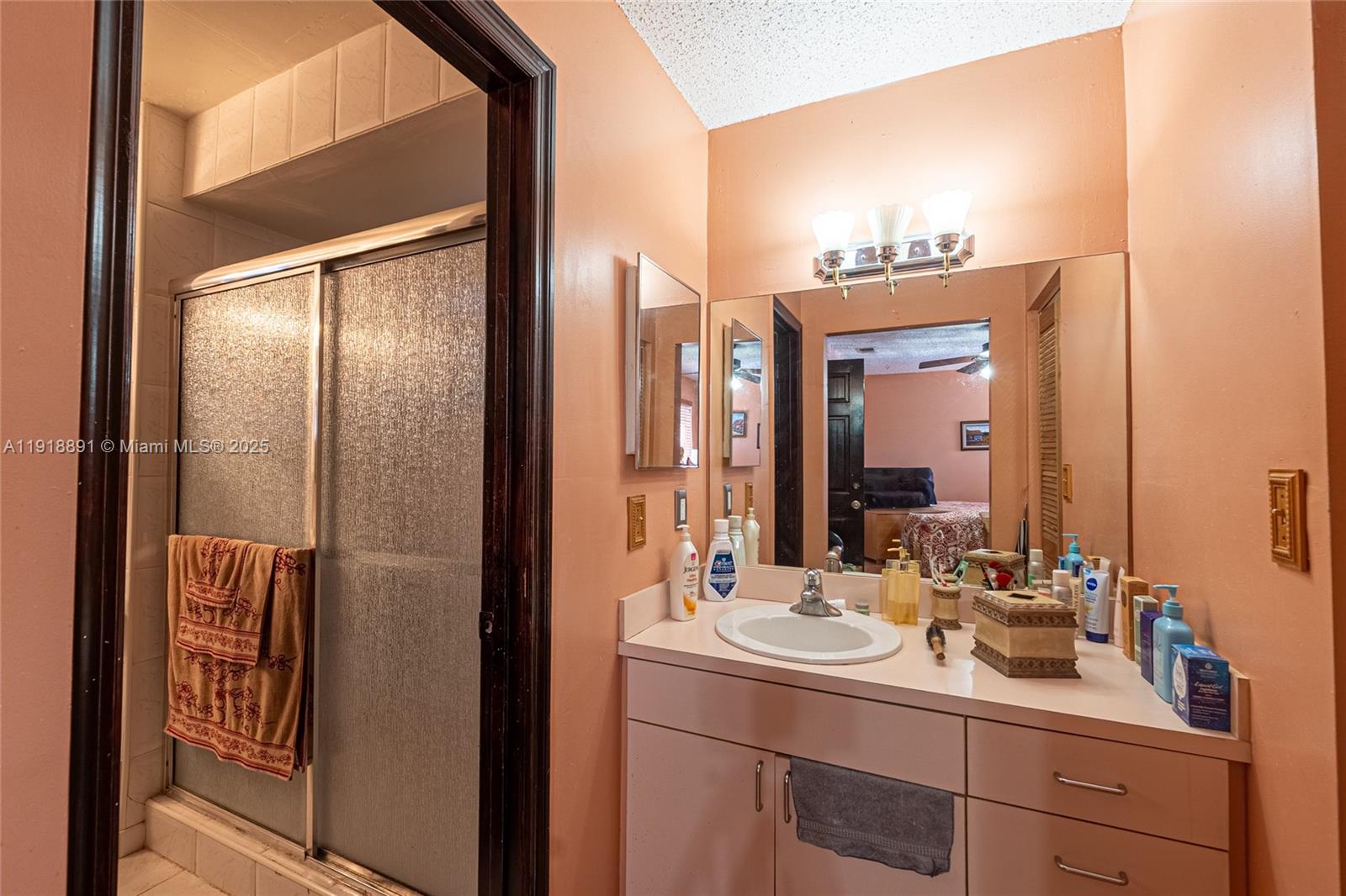 12421 Southwest 193rd Street Miami, FL 33177 - Photo 14 of 23 a bathroom with a double vanity sink and mirror