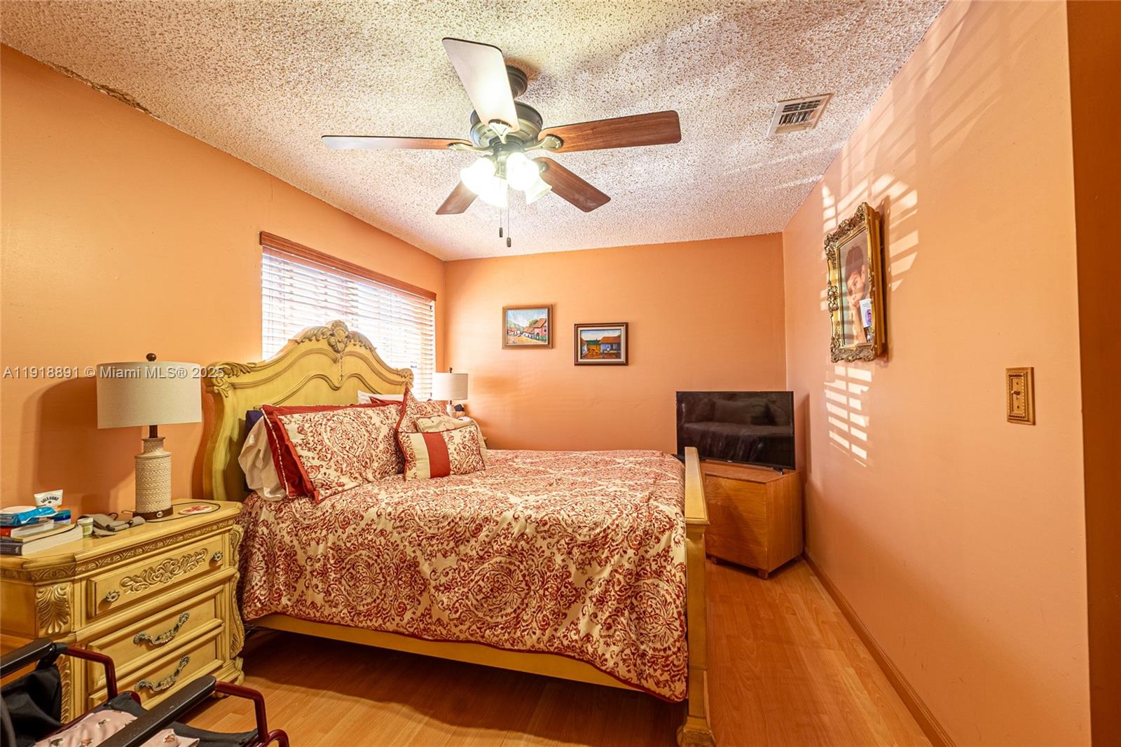 12421 Southwest 193rd Street Miami, FL 33177 - Photo 15 of 23 a bedroom with a bed and wooden floor