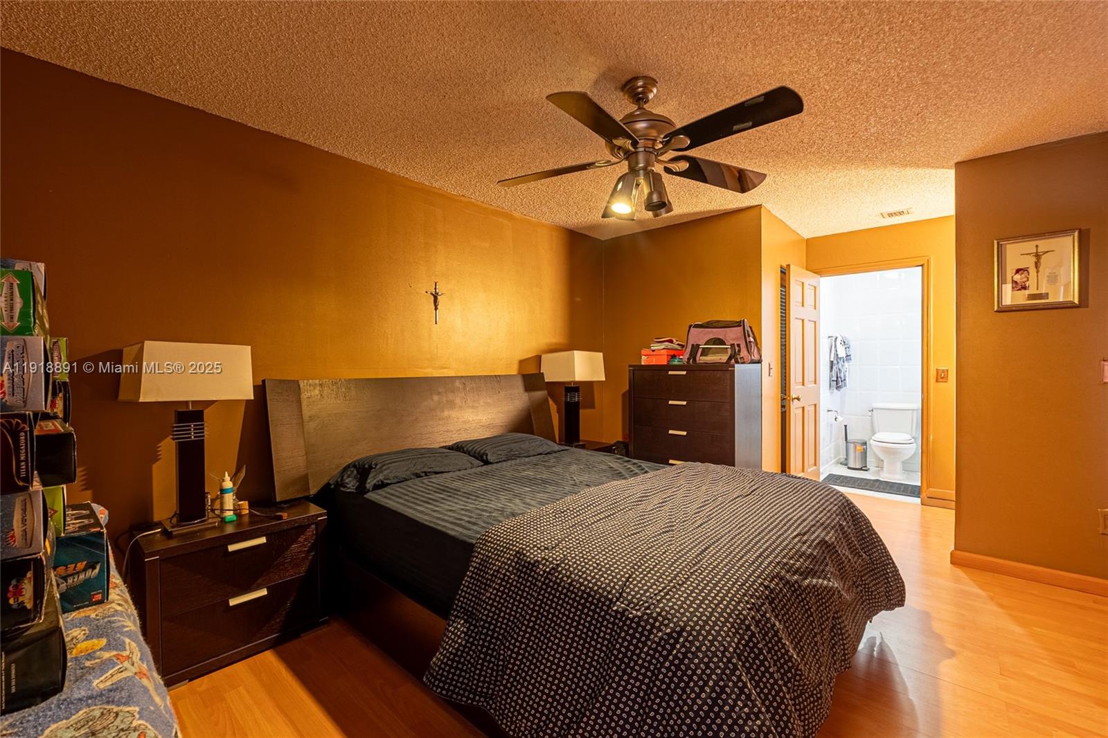 12421 Southwest 193rd Street Miami, FL 33177 - Photo 18 of 23 a bed room with a bed and a chandelier