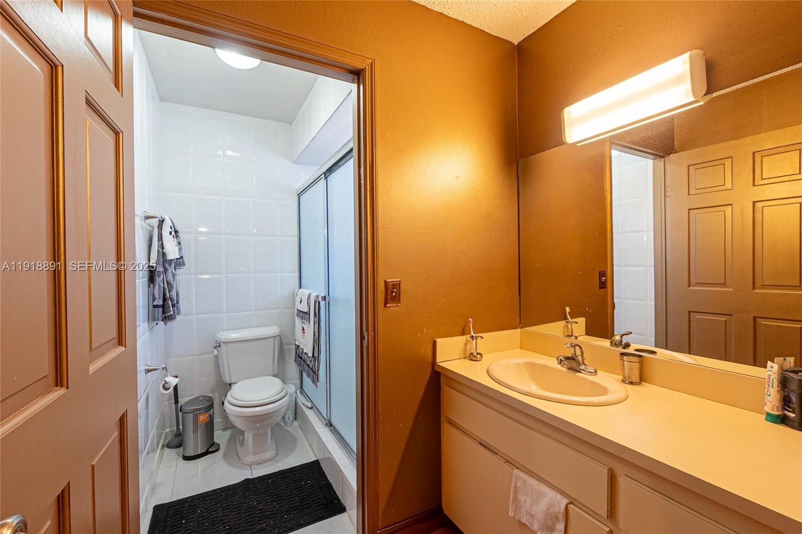 12421 Southwest 193rd Street Miami, FL 33177 - Photo 19 of 23 a bathroom with a sink a toilet and a shower
