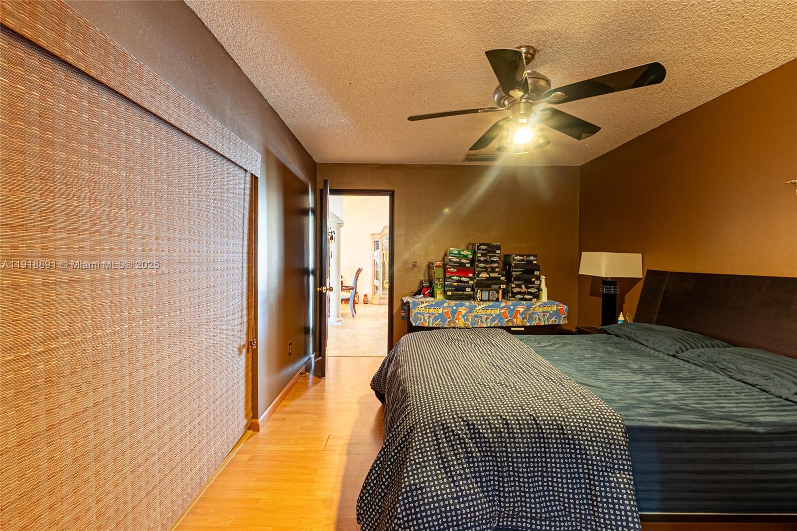 12421 Southwest 193rd Street Miami, FL 33177 - Photo 20 of 23 a bedroom with a bed and a chandelier