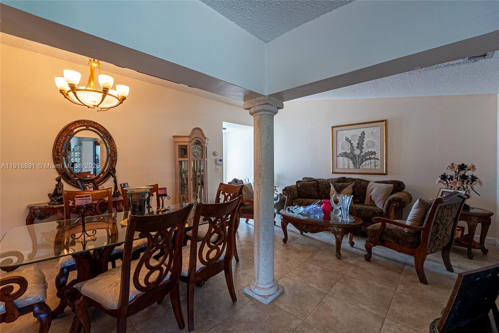 12421 Southwest 193rd Street Miami, FL 33177 - Photo 7 of 23 a living room with furniture a rug and a chandelier