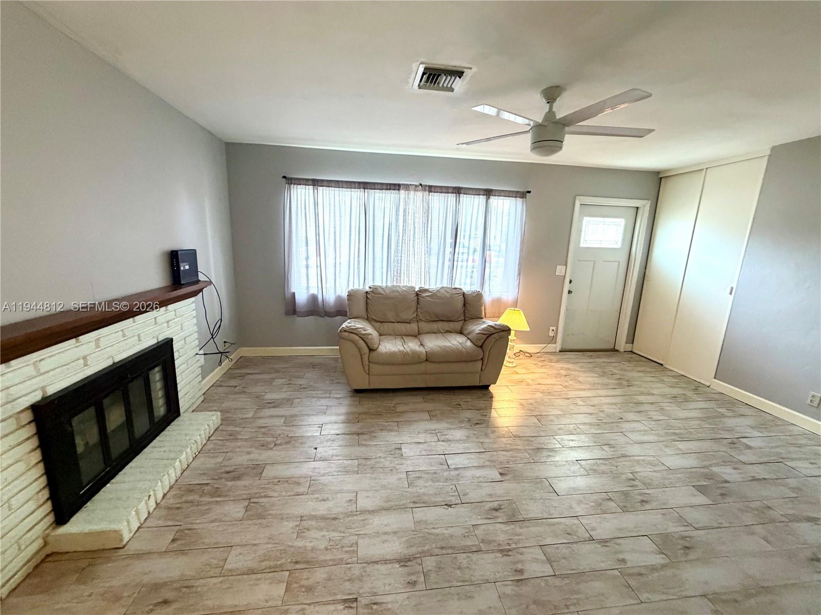 935 Churchill Road West Palm Beach, FL 33405 - Photo 2 of 10 a living room with furniture and a fireplace