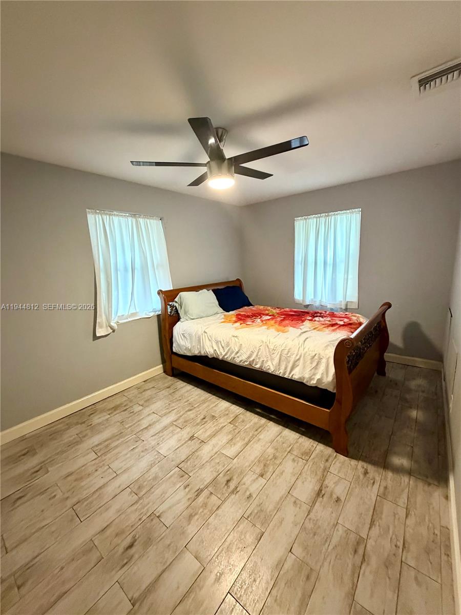 935 Churchill Road West Palm Beach, FL 33405 - Photo 4 of 10 a bedroom with a bed and a ceiling fan