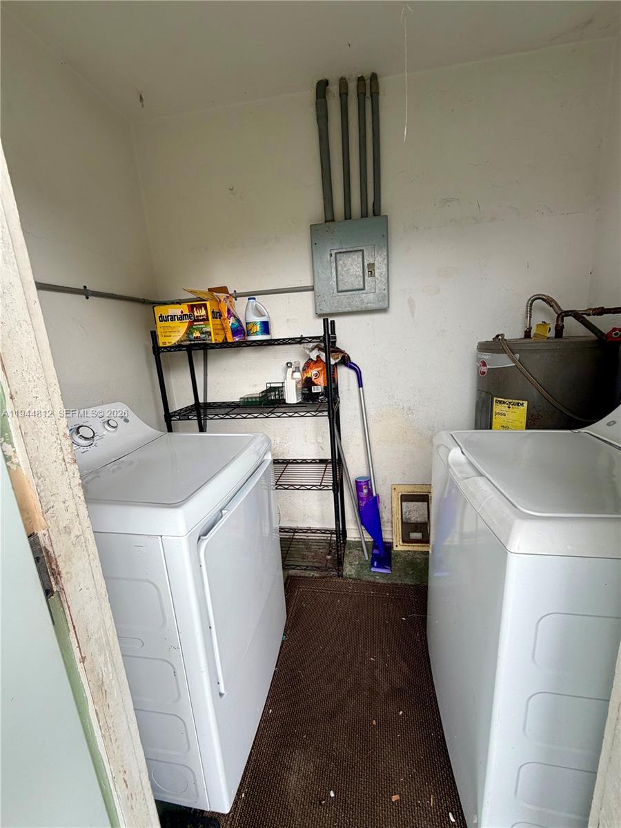 935 Churchill Road West Palm Beach, FL 33405 - Photo 8 of 10 a storage room with washer and dryer