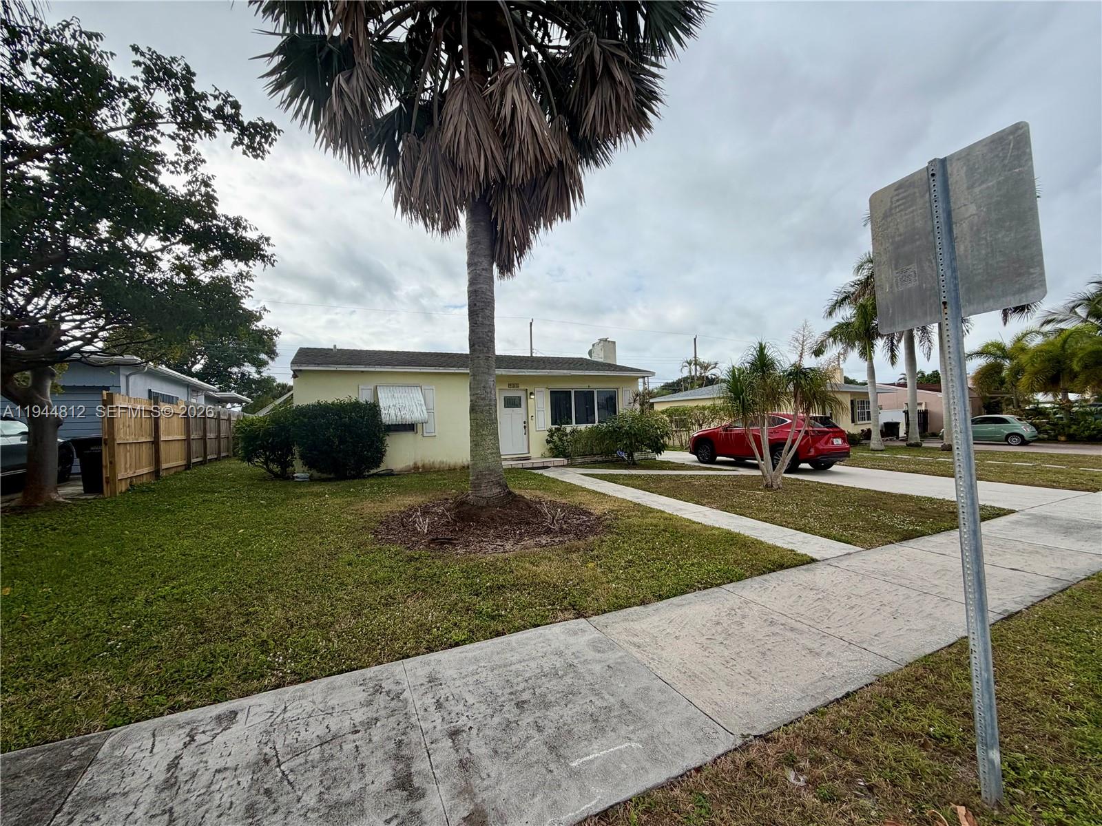 935 Churchill Road West Palm Beach, FL 33405 - Photo 10 of 10 a view of a white house with a large trees