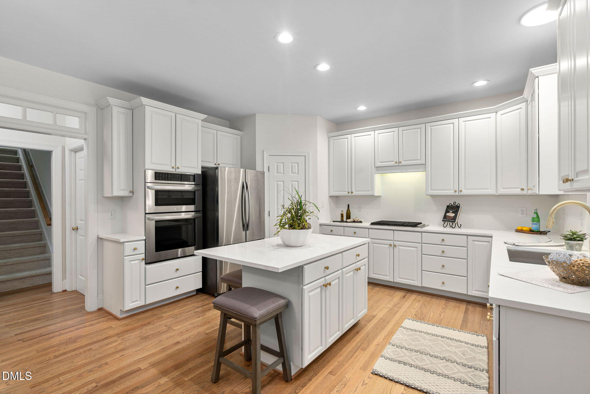 310 Hogans Valley Way Cary, NC 27513 - Photo 18 of 49 a kitchen with white cabinets and stainless steel appliances