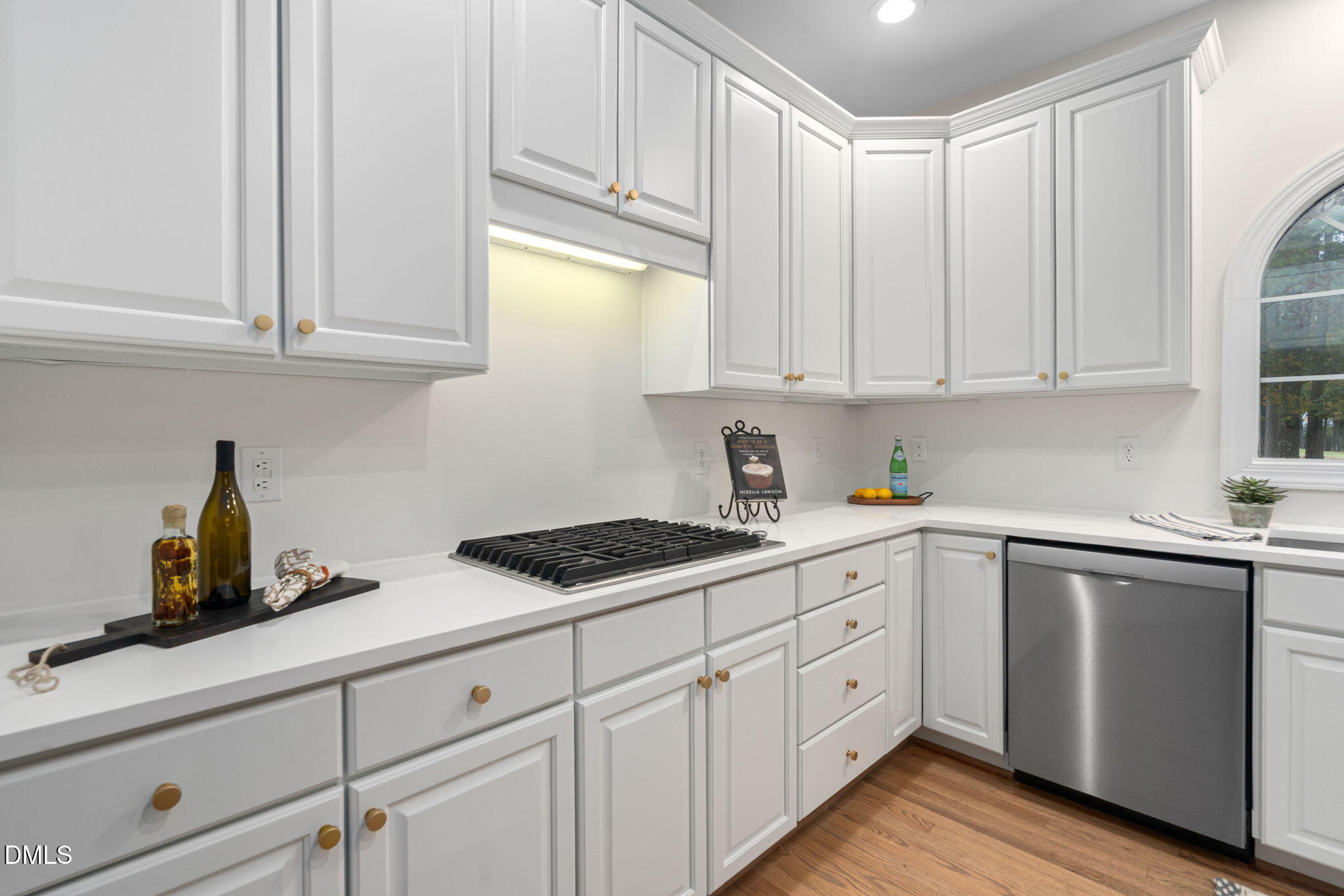 310 Hogans Valley Way Cary, NC 27513 - Photo 19 of 49 a kitchen with white cabinets and white appliances