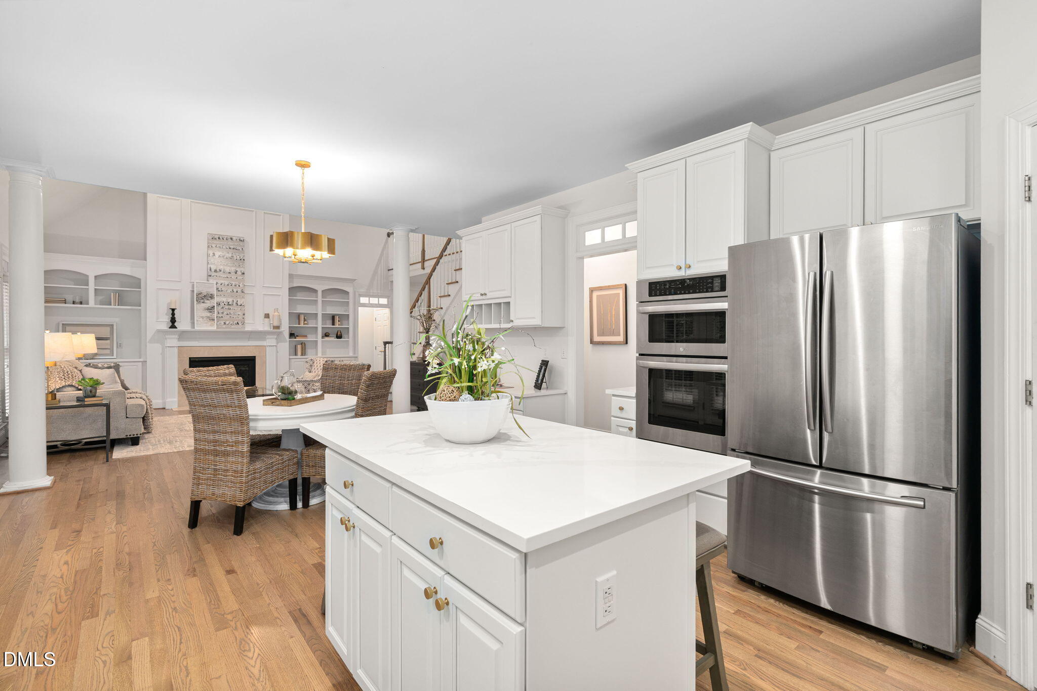310 Hogans Valley Way Cary, NC 27513 - Photo 21 of 49 a kitchen that has a refrigerator a stove and white cabinets with wooden floor