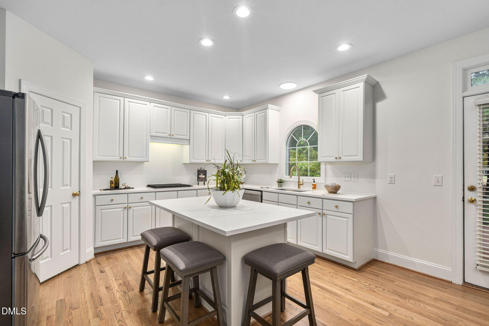 310 Hogans Valley Way Cary, NC 27513 - Photo 6 of 49 a kitchen with sink a refrigerator and wooden cabinets