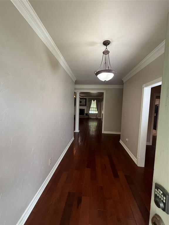 201 Woodhaven Drive Minden, LA 71055 - Photo 3 of 31 Entryway featuring wood-finish flooring, crown molding, and a decorative pendant light