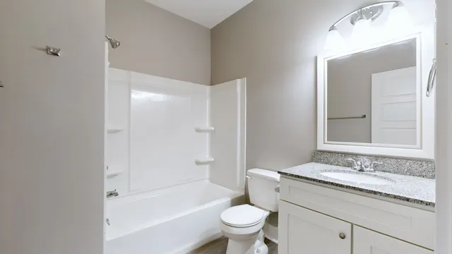 a view of an empty room and chandelier fan