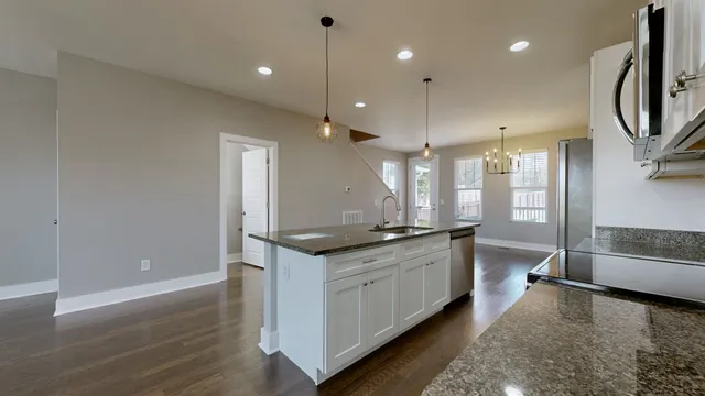 a kitchen with stainless steel appliances granite countertop a stove and a sink