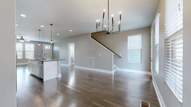 a view of entryway and kitchen with wooden floor