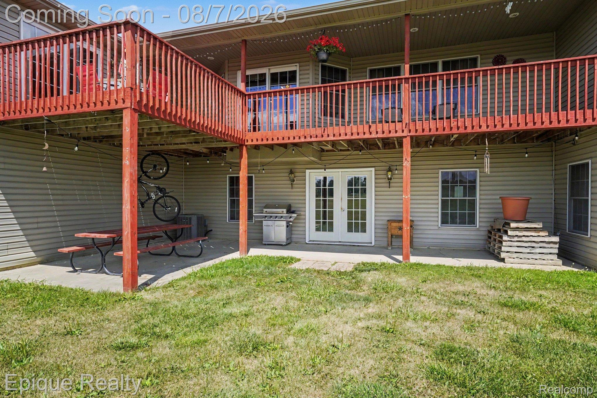 2288 Daley Road Lapeer, MI 48446 - Photo 23 of 30 Multi-level outdoor living space featuring an upper level wood deck, lower-level concrete patio, and direct access through French doors on both levels