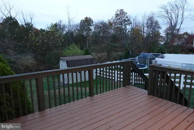 a balcony with wooden floor and fence