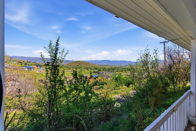 380 Luzern Road Midway, UT 84049 - Photo 37 of 74 Expansive mountain and valley scenery observed from a covered porch featuring a white railing