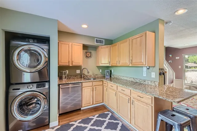 a kitchen with a sink a stove and cabinets