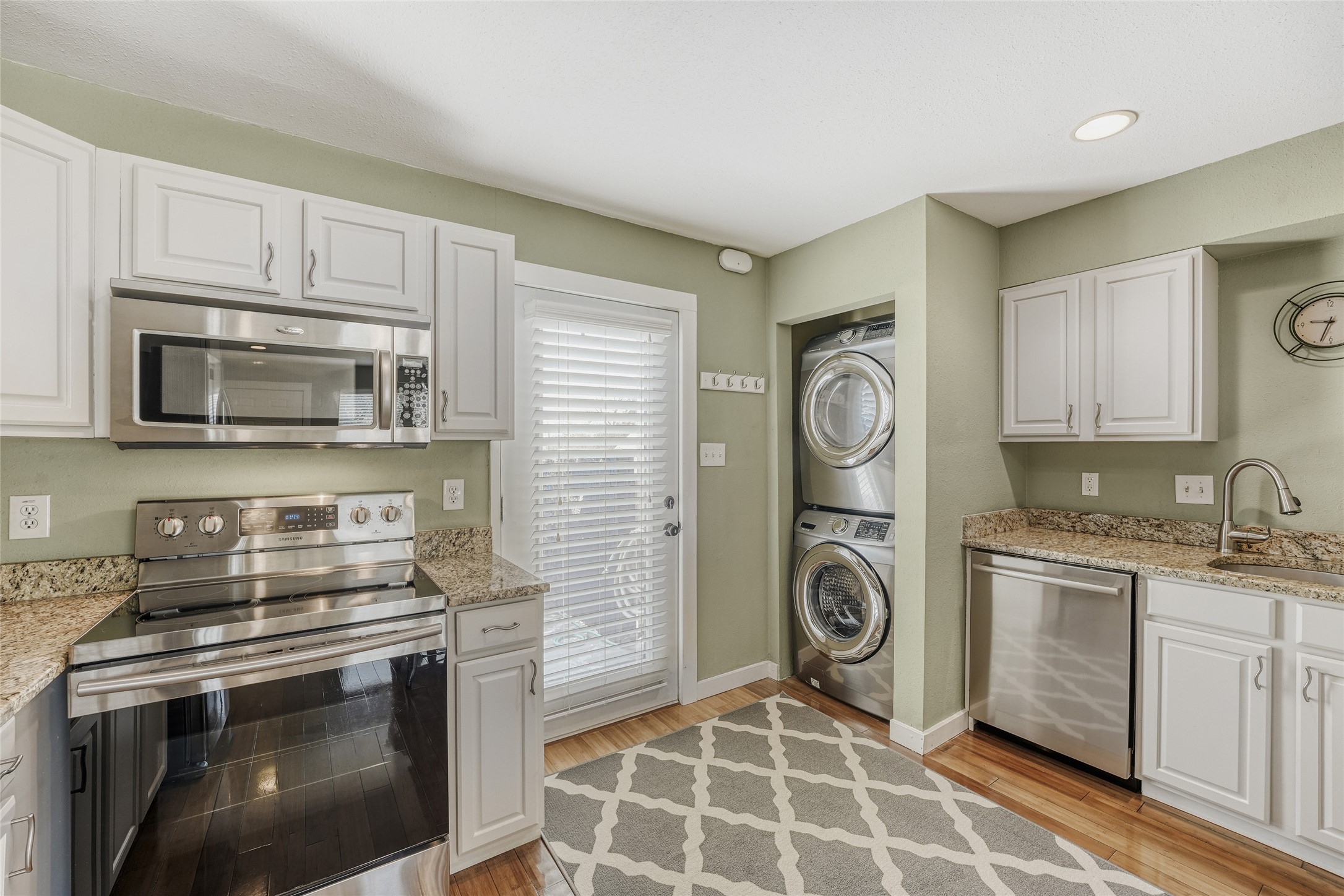 2000 Lightsey Road, Unit 3 Austin, TX 78704 - Photo 7 of 29 Kitchen with stainless steel appliances, white cabinetry, and light stone counters
