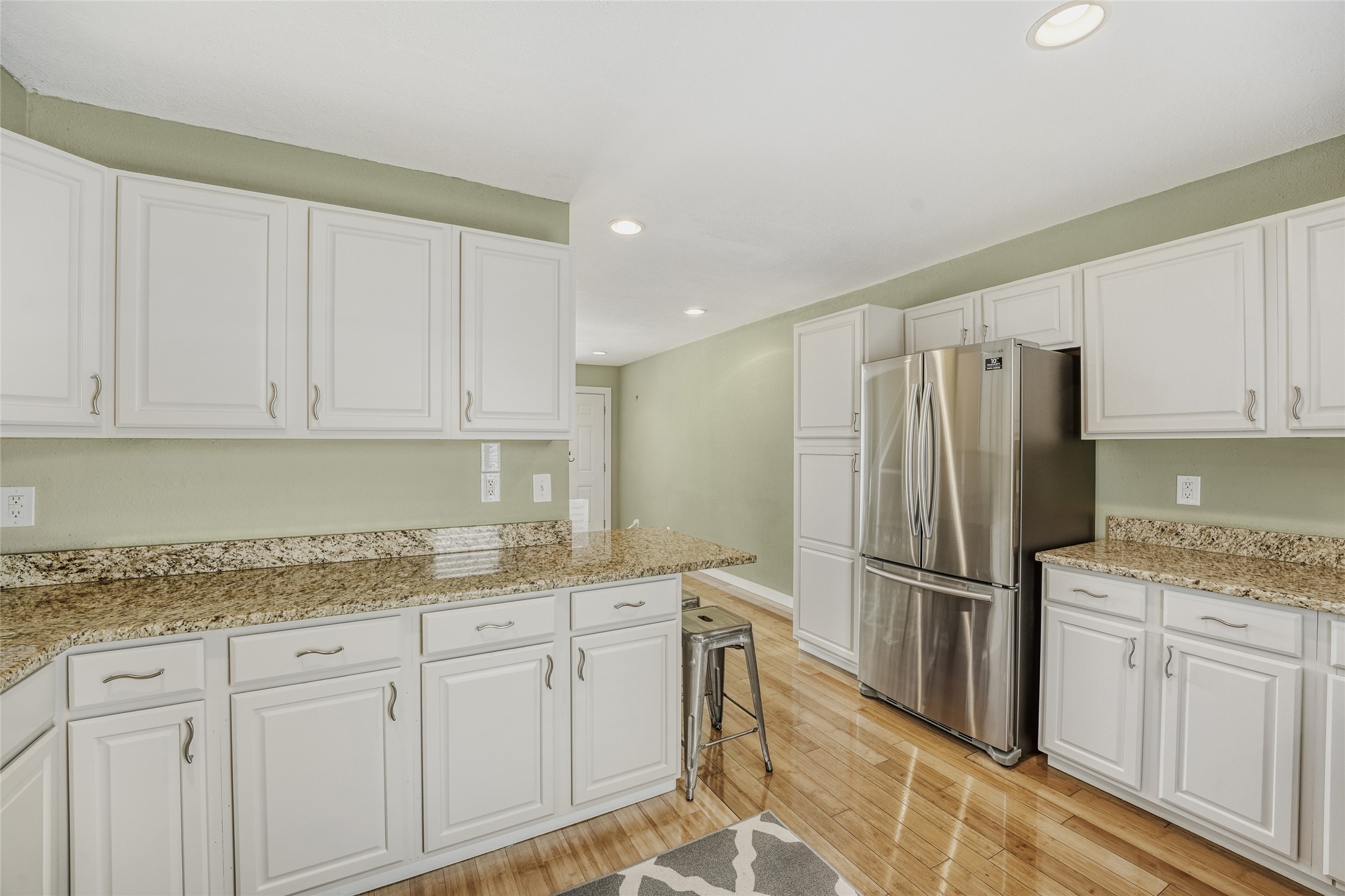 2000 Lightsey Road, Unit 3 Austin, TX 78704 - Photo 9 of 29 Kitchen featuring white cabinetry, freestanding refrigerator, light stone countertops, and recessed lighting