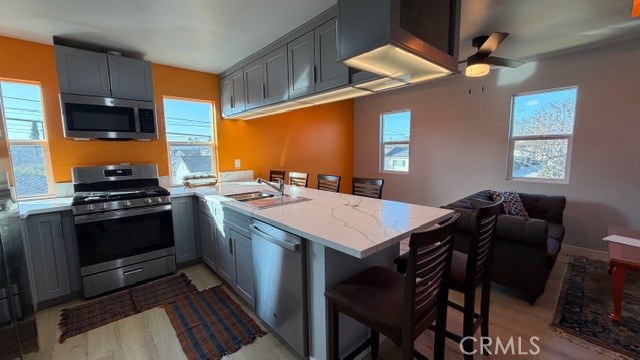 2413 La Crescenta Avenue, Unit A Alhambra, CA 91803 - Photo 1 of 11 a kitchen with a stove a sink and a refrigerator