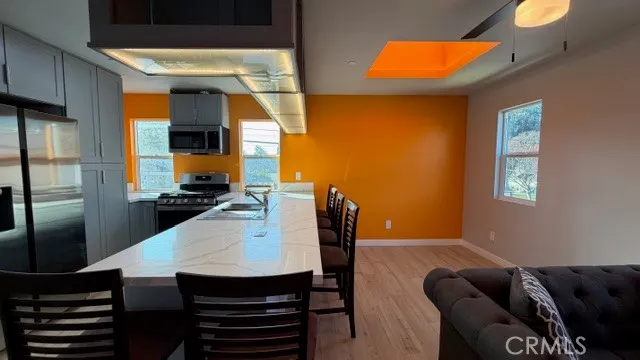 a kitchen with a stove a sink and a refrigerator